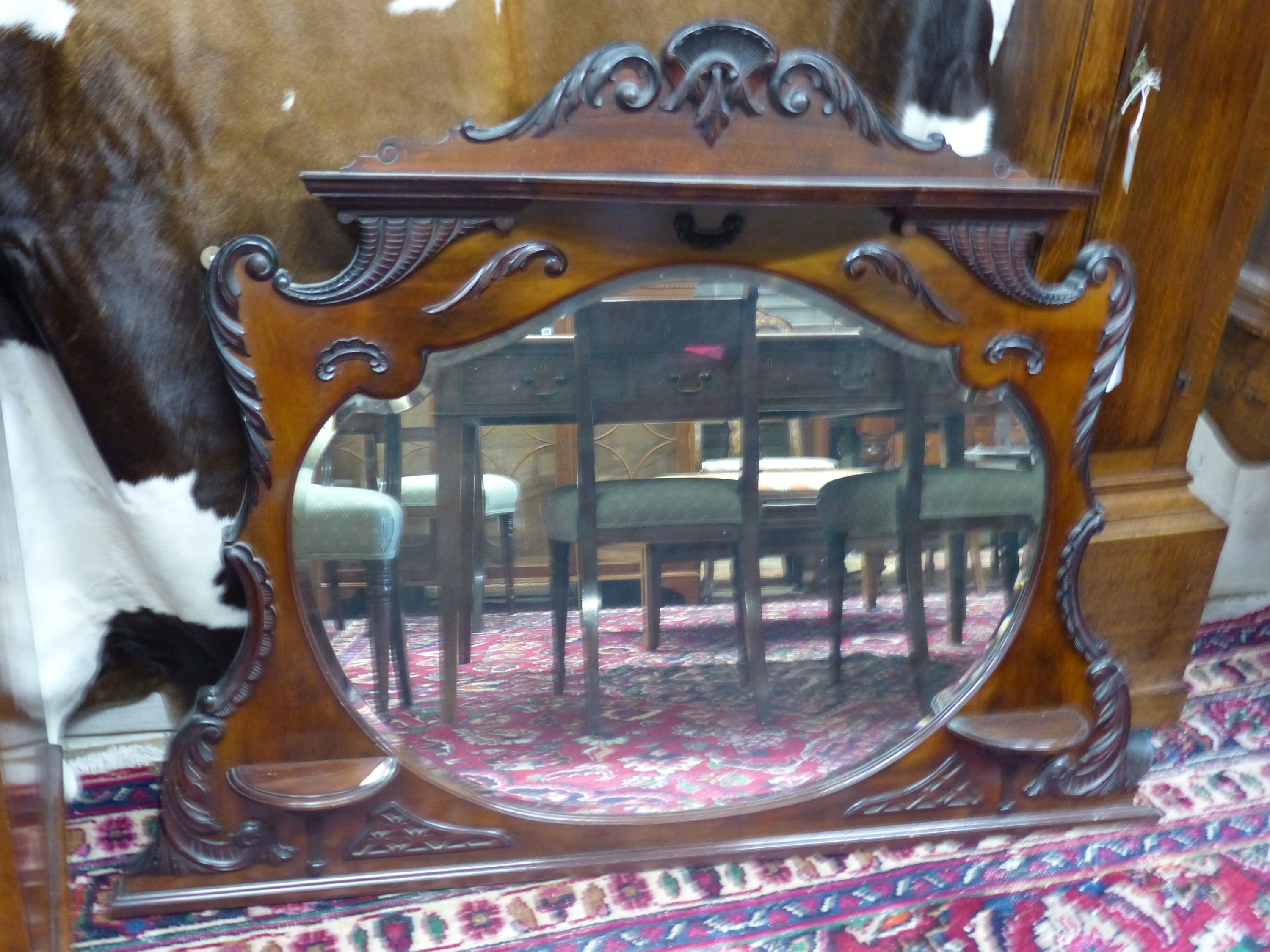 A late Victorian mahogany overmantel mirror, width 135cm, height 100cm